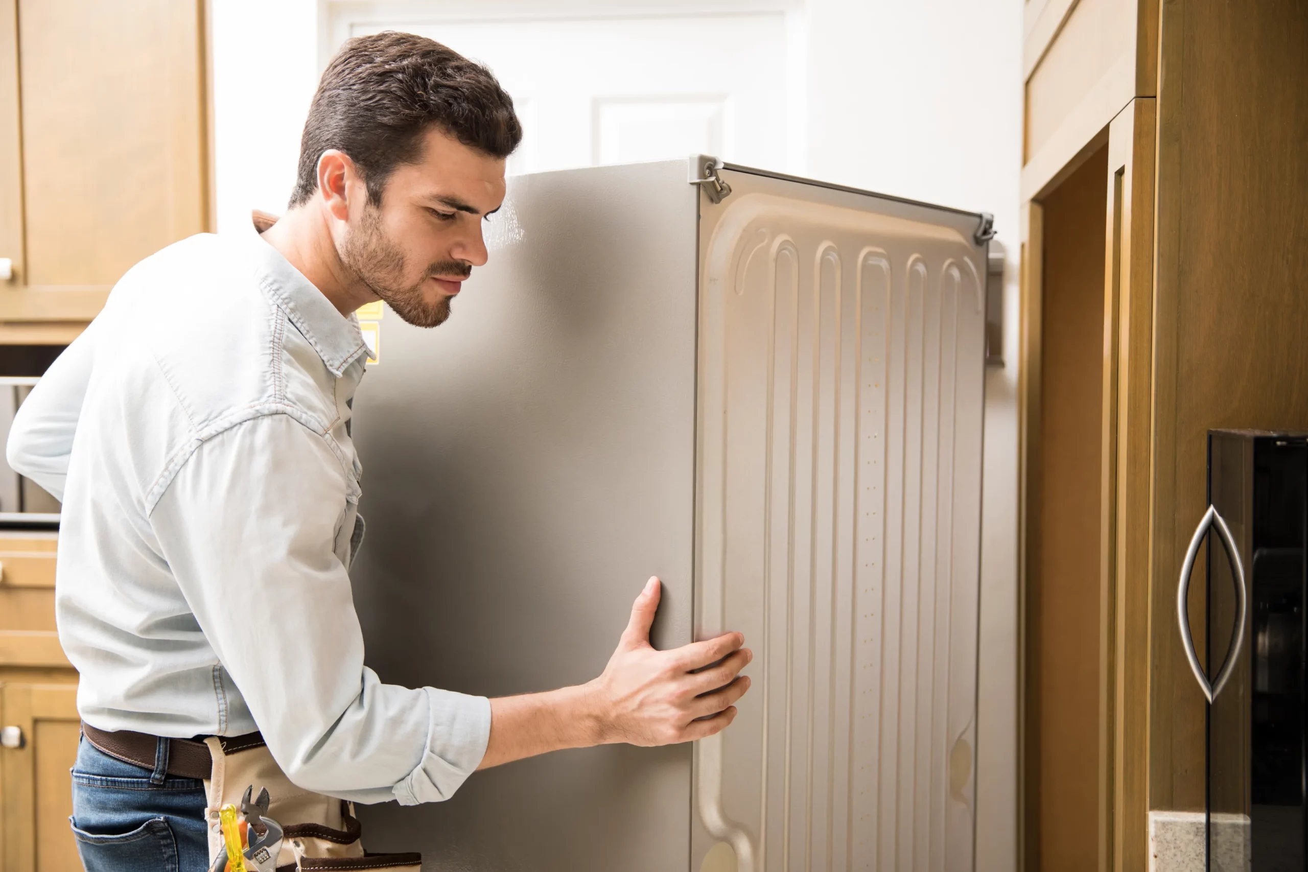 Appliance Repair Man Checking fridge