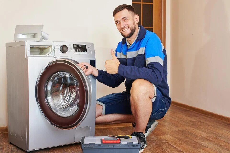 Satisfied repair man after repairing washing machine in Ottawa
