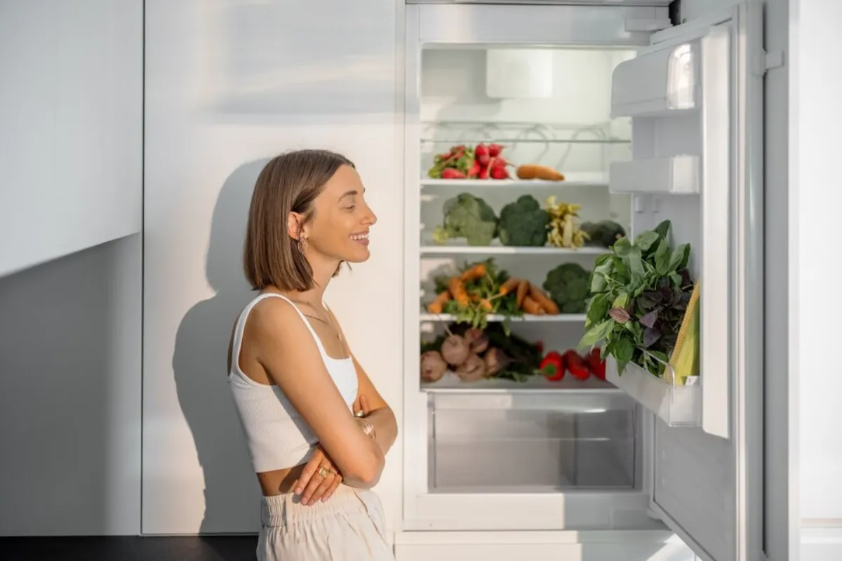 A woman enjoying having a GE fridge