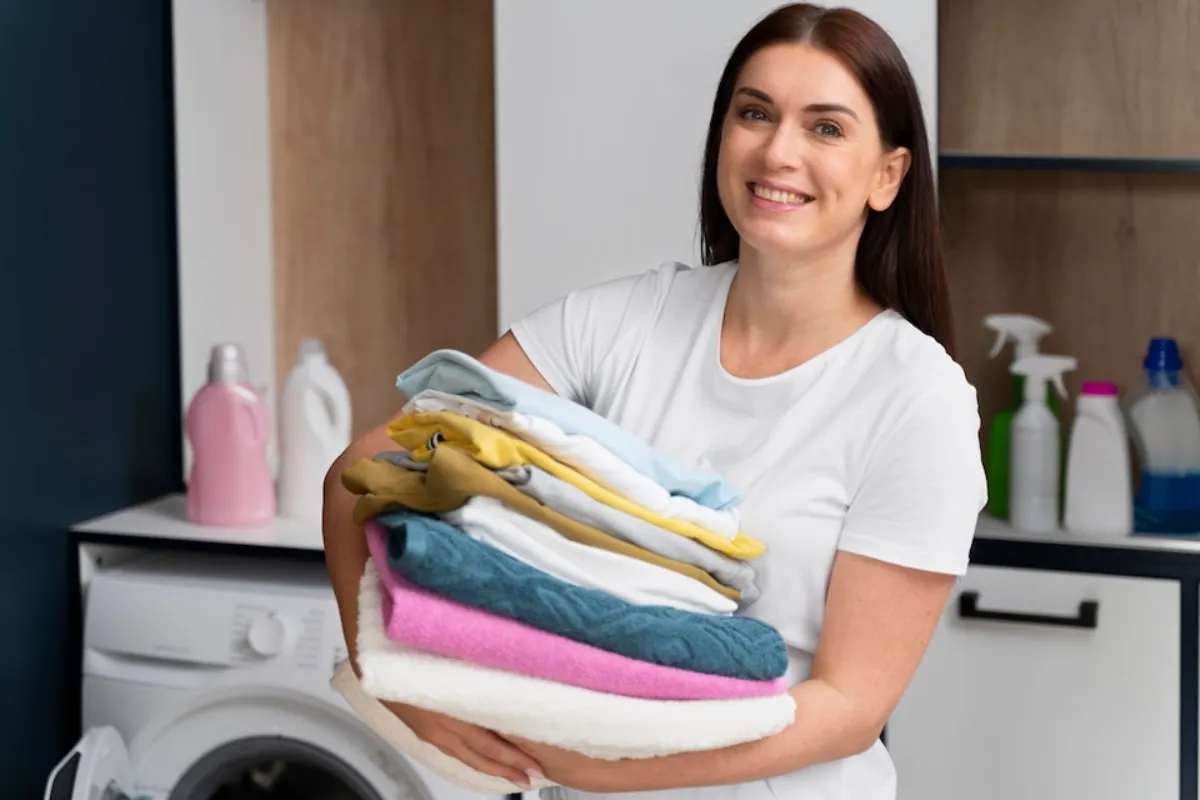 A woman holding clean washed by GE washer