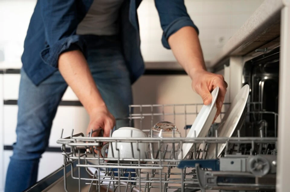 A man putting dishes in Samsung dishwasher