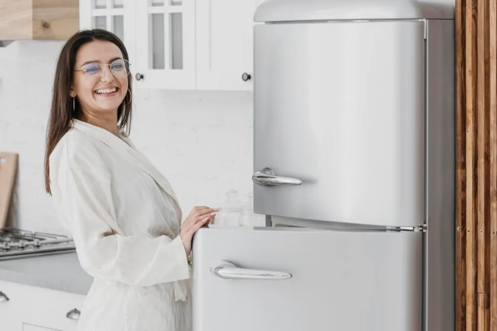 Happy woman beside Kenmore fridge