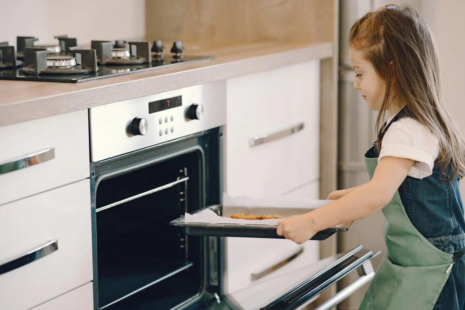 A child baking cookie in Samsung oven in Ottawa
