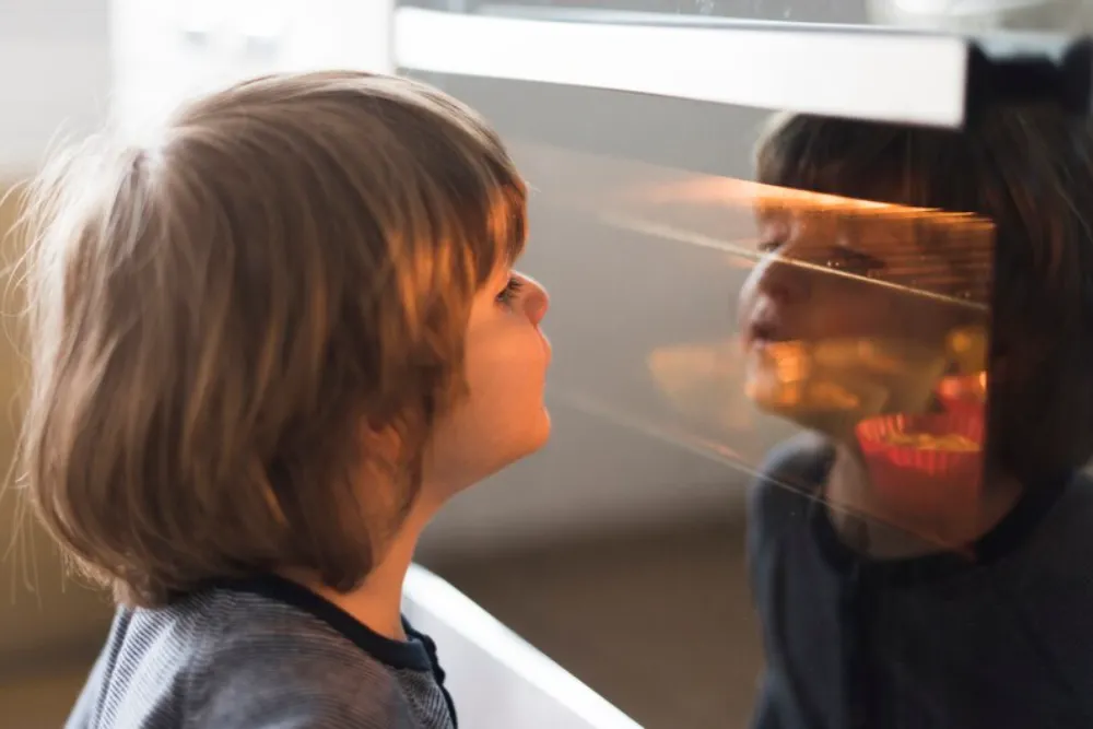 A boy looking at whirlpool oven
