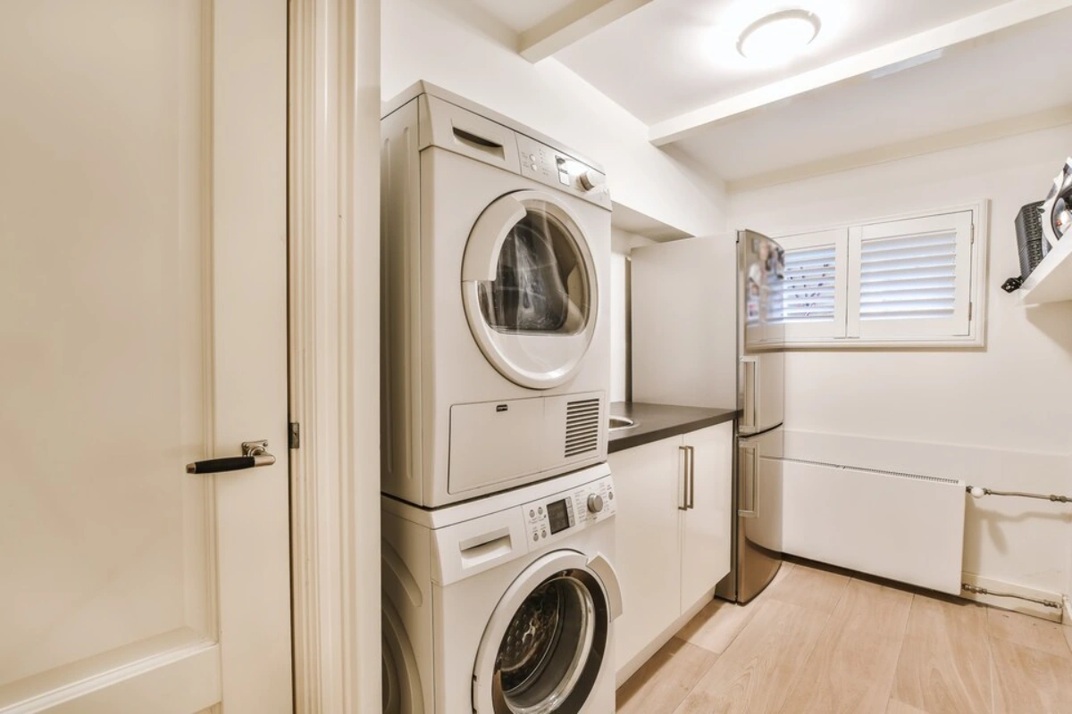 Tidy laundry area with fully functional washer and dryer in Kanata