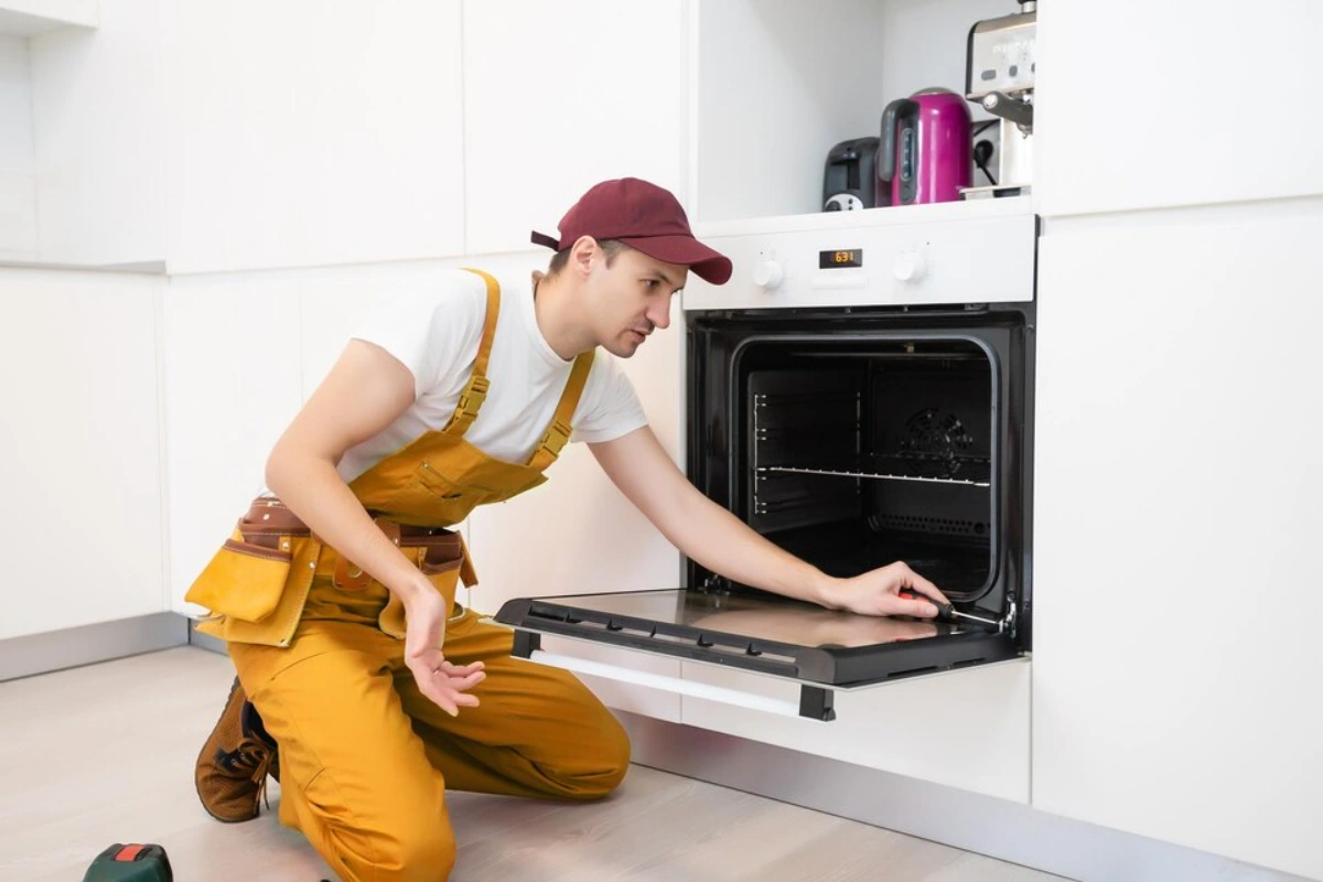 Experienced technician working on an oven repair in Orleans