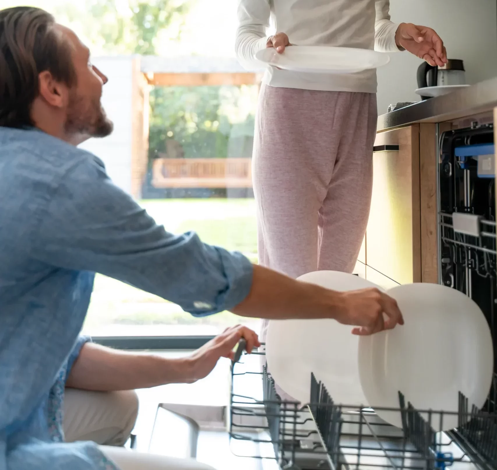 Couple using dishwasher at home in Ottawa