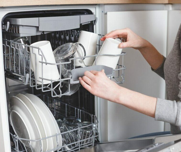 Woman using the dishwasher in Ottawa